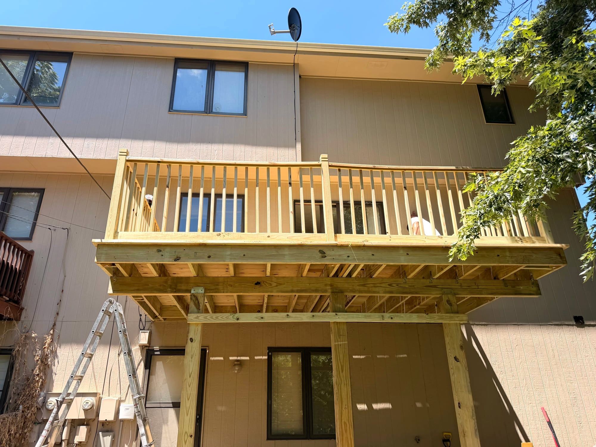 The same house with a new second-story deck and railings
